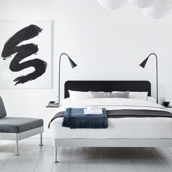A black headboard and two matching side tables can be easily removed from the Delaktig bed frame to create a whole new look in minutes.